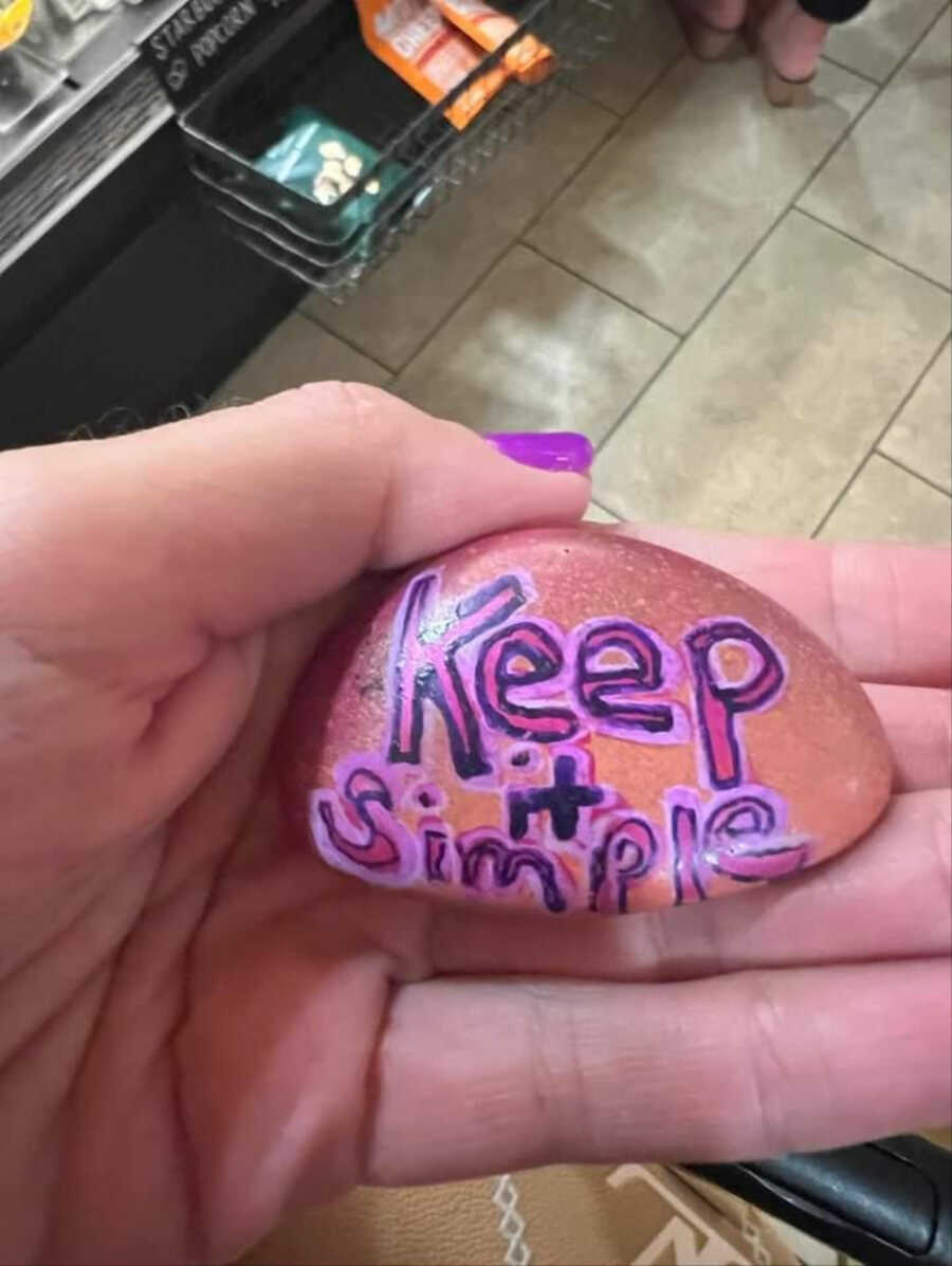 Hand painted rock that says 'Keep It Simple'