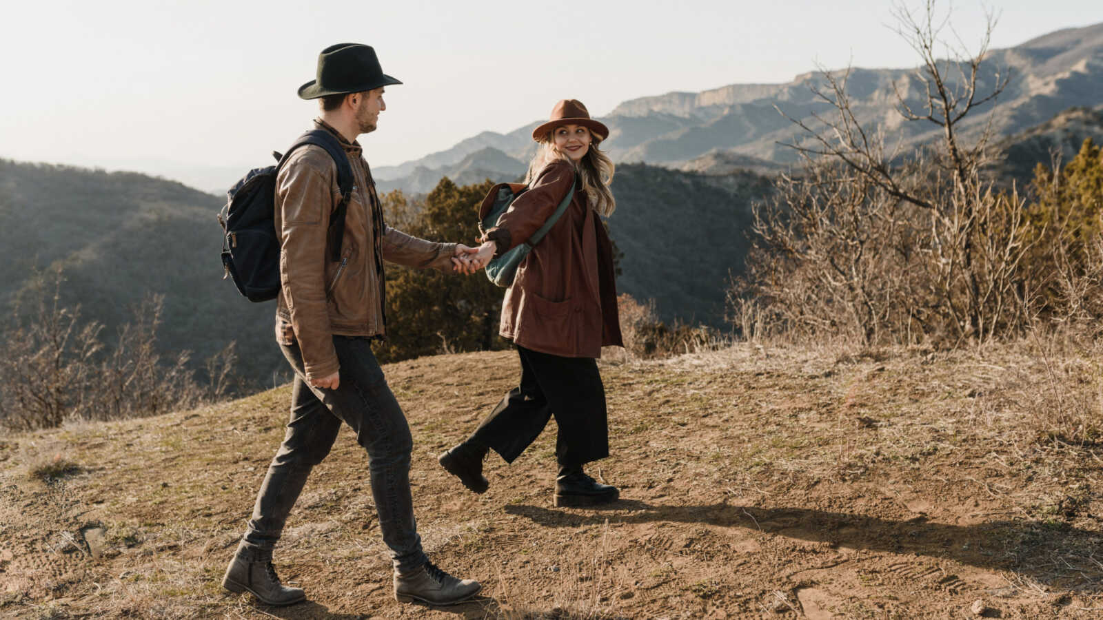 a young couple hiking outdoors during fall