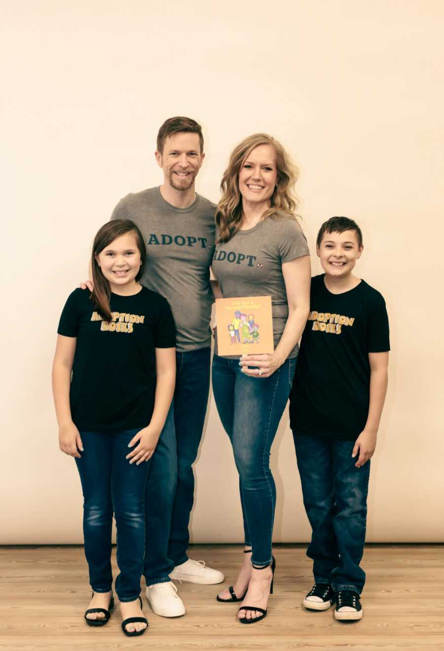 Adoptive family wearing matching adoption shirts