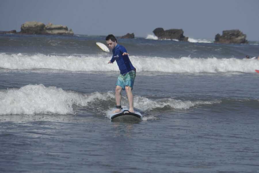 Teen with Down syndrome surfing