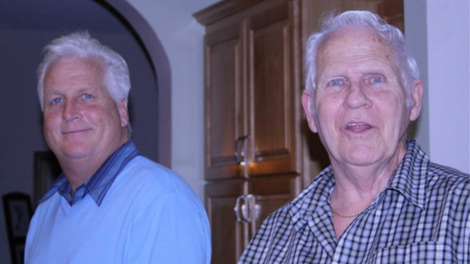 Father and son smiling into camera